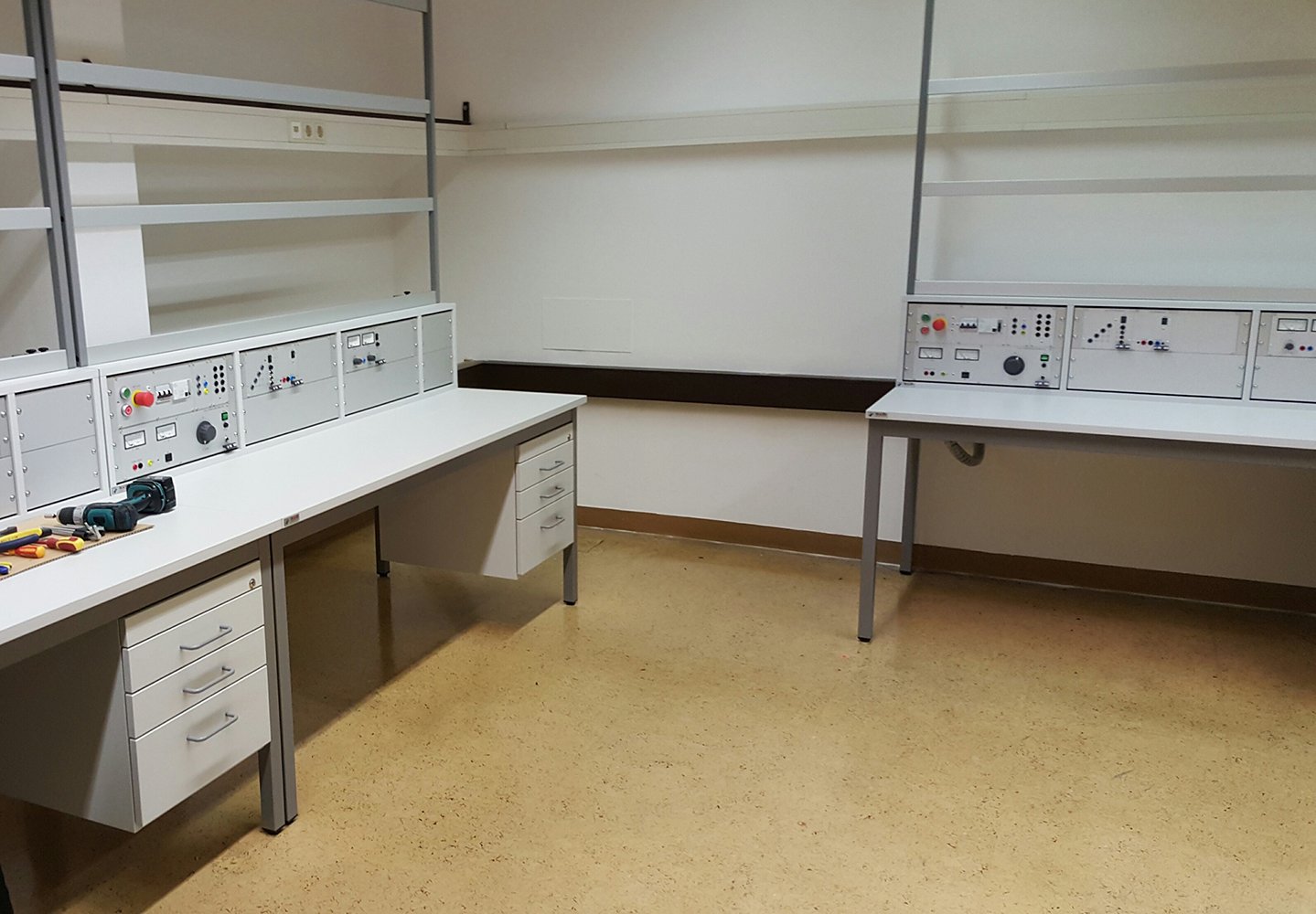 Laborraum mit Arbeitstischen, Schubladenelementen und Aufbaurahmen